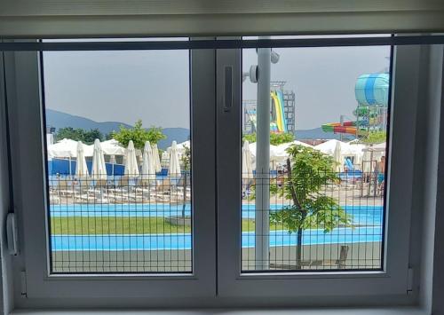 a view of a pool seen through a window at Apartmani Martenovic 1 in Vrnjačka Banja