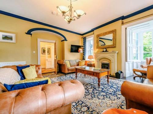 a living room with a couch and a fireplace at Oak Lodge in Keswick