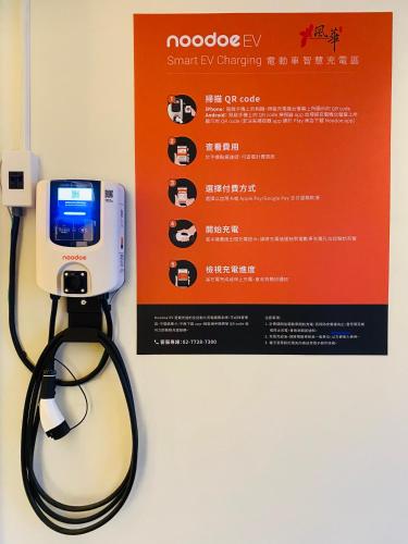 a phone with a cord hooked up to a sign at Orient Luxury Villa Motel in Huwei