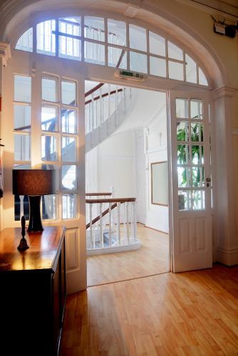 a large room with a large door and a staircase at Guesthouse Tricana de Aveiro in Aveiro