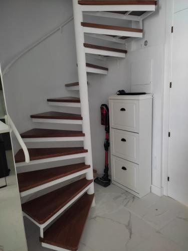 a staircase in a room with a white wall at Penthouse Las Americas first line de lux in Arona
