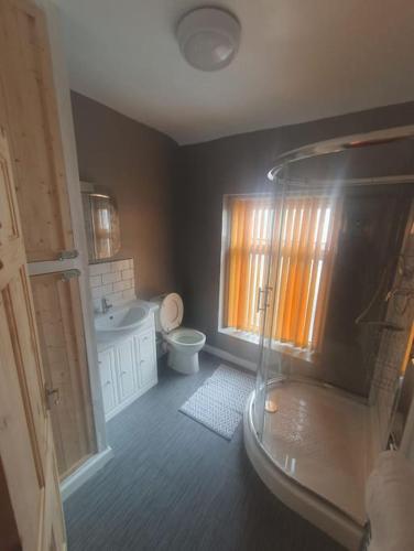 a bathroom with a tub and a toilet and a sink at Guardian View in Abertillery