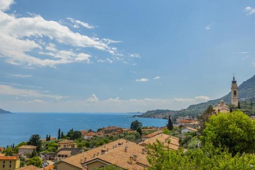 a view of a town with the ocean in the background at Hotel Meandro - Lake View in Gargnano