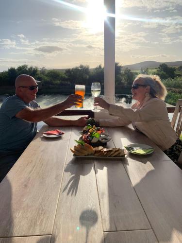 a man and woman sitting at a table with drinks at theLAB Robertson in Robertson