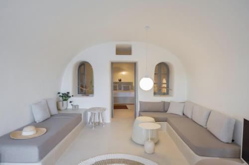 a living room with a couch and a table at Oia Waves by SV in Oia