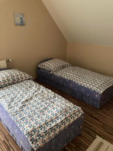 2 letti in una piccola camera con di Muskátli Apartman a Balatonakali