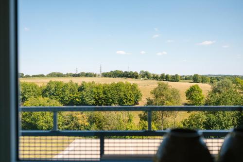 a view of a field from a window at Landhotel Heuvelzicht in Schin op Geul