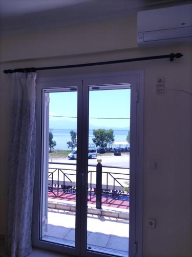 a sliding glass door with a view of the ocean at Eri's House in Cháni Milióni