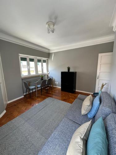 a living room with a couch and a table at Rooms to rent in a friendly apartment in Lisbon