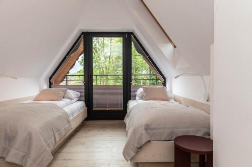 En eller flere senge i et værelse på TatryTop Apartament Everest