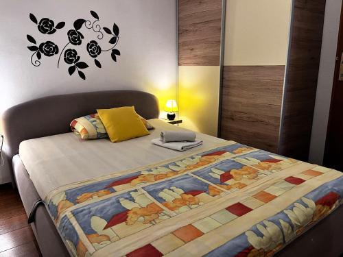 a bedroom with a bed with a quilt on it at Apartment Karma in Zadar