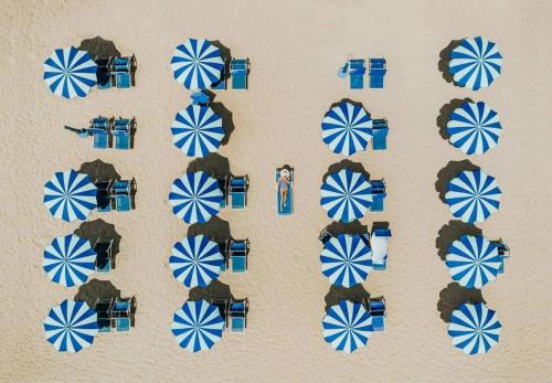 a bunch of blue and white umbrellas on a wall at All'Orologio - Boutique Hotel in Caorle