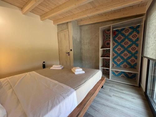 a bedroom with a bed and a door to a wine cellar at Stablus house in Alykes Potamou