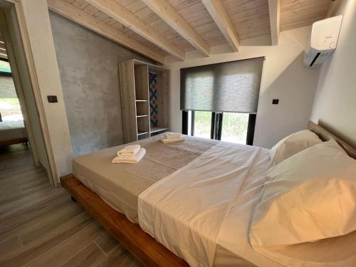 a bedroom with a large bed with towels on it at Stablus house in Alykes Potamou