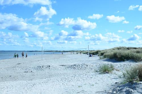 a beach with people playing soccer on it at BO GODT I SKAGEN.DK in Skagen