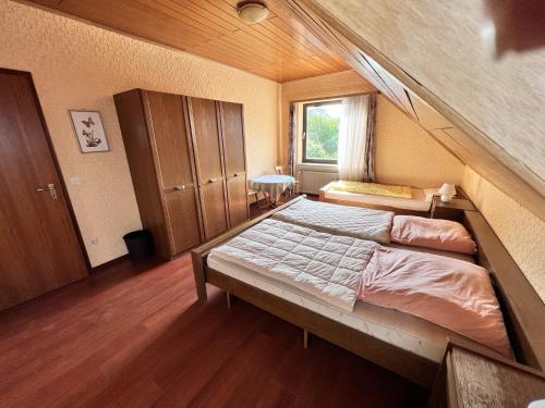 a bedroom with a large bed in a room at Landgasthof Zum Anker in Langenfeld