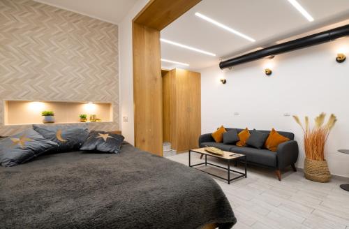 a bedroom with a large bed and a couch at Amazing Atmosphere- Bahai Gardens Main Street in Haifa