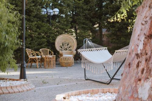 a couple of hammocks sitting in a park at Sourediko in Kambos