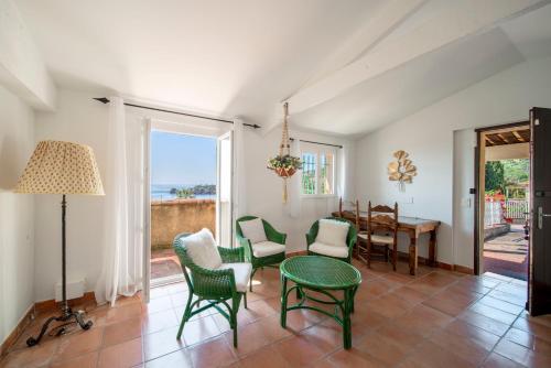 a living room with a table and chairs at Villa La Cigale Gaia's Villas in Théoule-sur-Mer