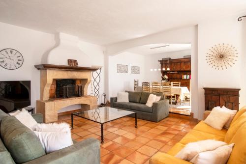 a living room with a couch and a fireplace at Villa La Cigale Gaia's Villas in Théoule-sur-Mer