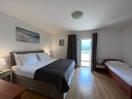 a hotel room with a bed and a window at Apartments Ana in Stari Grad