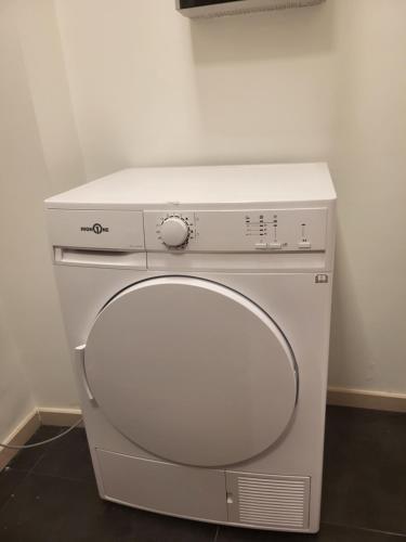 a white washing machine sitting in a room at Duplex neuf 2 chambres HUY in Huy