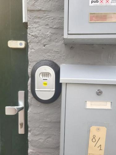 a lock on a door next to a wall with at Duplex neuf 2 chambres HUY in Huy