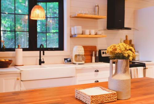 a kitchen with a vase of flowers on a table at Black Bear Lake Muskoka in Torrance