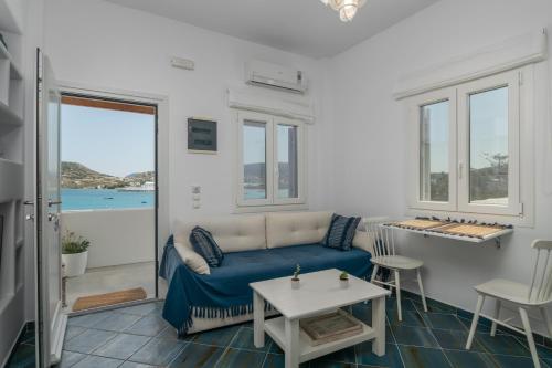 a living room with a couch and a table at Michalakis Seaside Suites in Pollonia