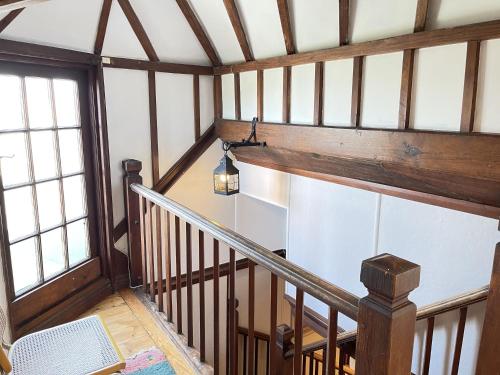 an overhead view of a staircase in a house at Stratton Vow - a true 1920s Arts and Crafts house! in St Ives