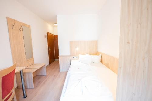 a room with a bed and a table in it at Hotel Astoria am Urachplatz in Stuttgart