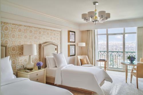 a hotel room with two beds and a window at Four Seasons Hotel Cairo at Nile Plaza in Cairo