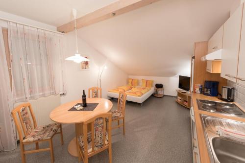 a small kitchen with a table and a couch at Appartement Montanea in Schruns-Tschagguns