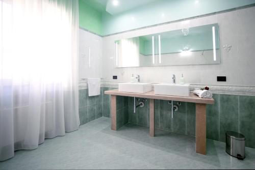 La salle de bains est pourvue de 2 lavabos et d'un miroir. dans l'établissement Vacanze Top, à Peschici