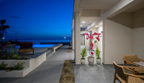 a house with a swimming pool at night at Amyntas Seafront Hotel in Neos Marmaras