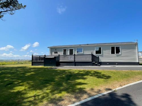 a mobile home with a porch and a yard at Holiday Home with Stunning Views in Newquay