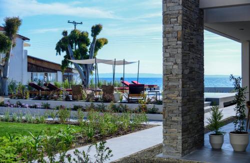 a patio with a view of the ocean at Amyntas Seafront Hotel in Neos Marmaras