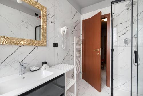 a bathroom with a sink and a mirror and a shower at Residence Paradiso Bilocale 202 in Moneglia