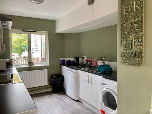 a kitchen with a washer and dryer in a room at Ludlow Mascall Centre in Ludlow