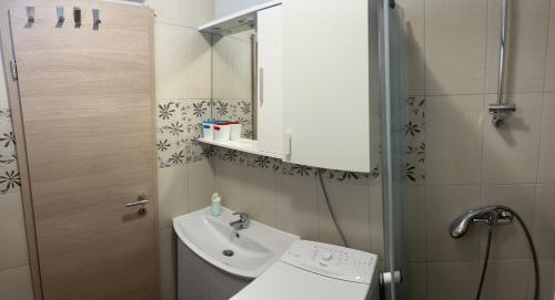 a small bathroom with a sink and a mirror at Holiday House Sanja Private Terrace BBQ in Peaceful Surroundings in Medulin