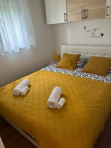 a bedroom with a bed with two towels on it at Holiday House Sanja Private Terrace BBQ in Peaceful Surroundings in Medulin