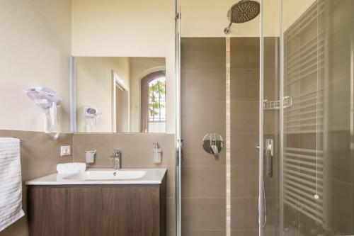 a bathroom with a sink and a shower at Podere La Quercia in San Gimignano