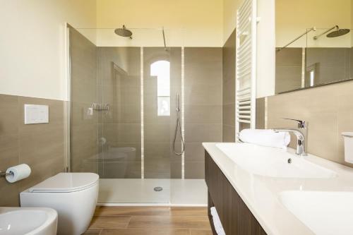 a bathroom with a shower and a toilet and a sink at Podere La Quercia in San Gimignano