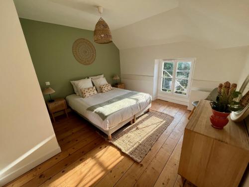 a bedroom with a bed and a potted plant at La Maison Pinot Noir in Gevrey-Chambertin
