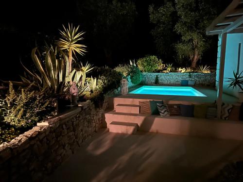 a swimming pool in a backyard at night at Villa del 1700 immersa nel verde, Poggio al Sole Vieste in Vieste