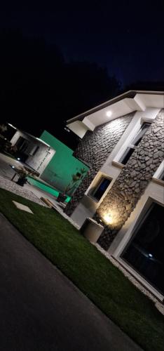 a building with a green door on the side of it at Resort TimAJA - pool, massage pool, sauna in Trebnje