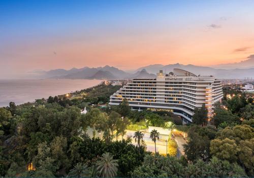 a hotel with a view of the ocean and mountains at MEDWORLD Health & Rehabilitation Center Rixos Antalya in Antalya