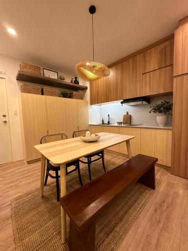 a dining room with a table and a bench at NUVALI Amaia Steps Parkway 2 BR Condo THE SANCTUARY with pool, free parking near Carmelray Industrial Park, Ayala Solenad, Xavier School in Pitland