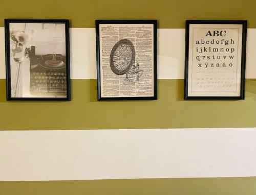 a wall with three framed pictures on it at Appartamento San Niccoló GR in Florence