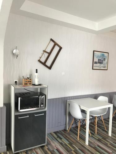 a kitchen with a table and a microwave at Monts et Rêves in Ramonchamp